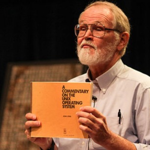 Brian Kernighan holding Lions Commentary at Dennis Ritchie's tribute in 2012